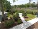 Relaxing hot tub area with a landscaped walkway and lush greenery at 311 69Th Ave. N # 104, Myrtle Beach, SC 29572