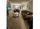 Spacious living room with ample seating and view into dining area at 311 69Th Ave. N # 104, Myrtle Beach, SC 29572