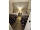 Two twin beds in a well-lit bedroom with wood floors at 311 69Th Ave. N # 104, Myrtle Beach, SC 29572
