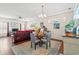 Bright living room features hardwood floors, a comfy leather couch, and a dining area at 154 Terracina Circle, Myrtle Beach, SC 29588