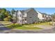 Two-story townhome with light beige siding and landscaping at 154 Terracina Circle, Myrtle Beach, SC 29588