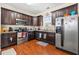 Well-equipped kitchen with dark wood cabinets, granite countertops, and stainless steel appliances at 154 Terracina Circle, Myrtle Beach, SC 29588