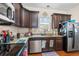 Kitchen with dark wood cabinets, granite countertops, and stainless steel appliances at 154 Terracina Circle, Myrtle Beach, SC 29588