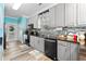 Kitchen with gray cabinets, black countertops, and tile backsplash at 6001-7038 S Kings Hwy., Myrtle Beach, SC 29575