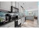 Kitchen with gray cabinets, black appliances, and tile backsplash at 6001-7038 S Kings Hwy., Myrtle Beach, SC 29575