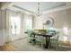 Elegant dining room with a chandelier, large windows, and a farmhouse table at 5063 Selene Ct., Myrtle Beach, SC 29588