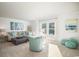 Bright living room features a comfy sectional sofa, accent chairs, and large windows at 5063 Selene Ct., Myrtle Beach, SC 29588