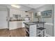 Bright kitchen with white cabinets, granite countertops, and breakfast bar at 14290 Ocean Hwy. # 202, Pawleys Island, SC 29585