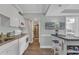 Well-equipped kitchen with white cabinets, granite countertops, and modern appliances at 14290 Ocean Hwy. # 202, Pawleys Island, SC 29585
