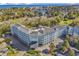 Aerial view of a coastal community with a large building and ocean in the distance at 14290 Ocean Hwy. # 202, Pawleys Island, SC 29585