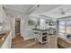 Open concept living room with kitchen, island, and access to a balcony at 14290 Ocean Hwy. # 202, Pawleys Island, SC 29585