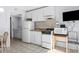 Small condo kitchen with white appliances and cabinets at 1600 S Ocean Blvd. # 346, Myrtle Beach, SC 29577