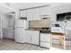 Condo kitchen with white appliances and bathroom access at 1600 S Ocean Blvd. # 346, Myrtle Beach, SC 29577