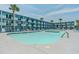 Inviting swimming pool with surrounding lounge chairs and palm trees at 1600 S Ocean Blvd. # 346, Myrtle Beach, SC 29577