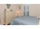 Bedroom with a dresser and bed with blue and white bedding at 5804 Longwood Dr. # 203, Murrells Inlet, SC 29576