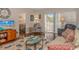 Comfortable living room with sofa, TV, and access to balcony at 5804 Longwood Dr. # 203, Murrells Inlet, SC 29576