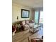 Living room with floral couch and wicker coffee table at 9580 Shore Dr. # 303, Myrtle Beach, SC 29572