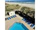 Community pool with plenty of lounge chairs at 9580 Shore Dr. # 303, Myrtle Beach, SC 29572