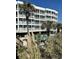 Building exterior with palm trees and pool at 9580 Shore Dr. # 303, Myrtle Beach, SC 29572