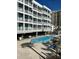 Community pool with lounge chairs at 9580 Shore Dr. # 303, Myrtle Beach, SC 29572