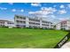 Multi-story building with a well-maintained lawn at 4220 Coquina Harbour Dr. # B-11, Little River, SC 29566