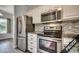 Modern kitchen featuring stainless steel appliances and granite countertops at 4220 Coquina Harbour Dr. # B-11, Little River, SC 29566