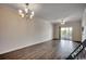 Bright living room showcasing hardwood floors and a chandelier at 4220 Coquina Harbour Dr. # B-11, Little River, SC 29566