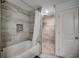 Bathroom with shower/tub combo and wood-look tile at 829 44Th Ave. N, Myrtle Beach, SC 29577