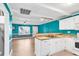 Open concept kitchen with white cabinets and teal walls at 519 31St Ave. N # 7, Myrtle Beach, SC 29577