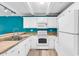 White kitchen with teal walls, stainless steel appliances at 519 31St Ave. N # 7, Myrtle Beach, SC 29577