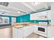 White kitchen with teal walls and stainless steel appliances at 519 31St Ave. N # 7, Myrtle Beach, SC 29577