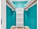 Bright white closet with wooden shelving and teal walls at 519 31St Ave. N # 7, Myrtle Beach, SC 29577