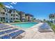 Community pool with plenty of lounge chairs for relaxing at 5601 N Ocean Blvd. # C-202, Myrtle Beach, SC 29577