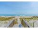 Wooden walkway leading to sandy beach and ocean at 5601 N Ocean Blvd. # C-202, Myrtle Beach, SC 29577
