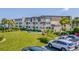 Exterior view of building with green lawn and parking at 5601 N Ocean Blvd. # C-202, Myrtle Beach, SC 29577