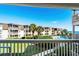 Balcony with partial ocean view, community pool view, and lush landscaping at 5601 N Ocean Blvd. # C-202, Myrtle Beach, SC 29577