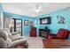 Relaxing living room with teal walls, comfortable seating, fireplace, and access to balcony at 5601 N Ocean Blvd. # C-202, Myrtle Beach, SC 29577