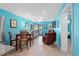 Bright living room with teal walls, tiled floors, comfortable seating, and dining area at 5601 N Ocean Blvd. # C-202, Myrtle Beach, SC 29577