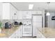 White kitchen with granite countertops and appliances at 201 74Th Ave. N # 2749/50, Myrtle Beach, SC 29572