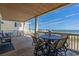 Spacious oceanfront deck features a table and chairs for outdoor dining at 132 N Waccamaw Dr., Murrells Inlet, SC 29576