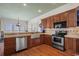Bright kitchen with farmhouse sink, stainless steel appliances, and wood cabinets at 132 N Waccamaw Dr., Murrells Inlet, SC 29576