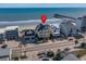 Aerial view of oceanfront property, showing home location near pier at 132 N Waccamaw Dr., Murrells Inlet, SC 29576