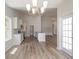 Bright dining room with chandelier, access to patio, and kitchen views at 612 Woodside Dr., Conway, SC 29526