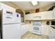 Clean kitchen features white cabinets, a microwave, and stove at 5825 Catalina Dr. # 324, North Myrtle Beach, SC 29582