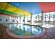 Indoor pool with colorful ceiling and lounge chairs at 6804 N Ocean Blvd. # 627, Myrtle Beach, SC 29572