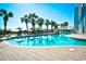 Large outdoor pool with palm trees and lounge chairs at 6804 N Ocean Blvd. # 627, Myrtle Beach, SC 29572