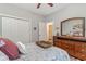 Bedroom with wooden dresser, paisley bedding, and ensuite bathroom access at 662 Sunnyside Dr. # 101, Murrells Inlet, SC 29576