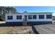 White single-story house with black shutters and stone base at 218 Eva Dr., Loris, SC 29569