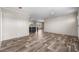 Living room with wood-look floors and kitchen view at 218 Eva Dr., Loris, SC 29569