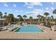 Community pool with lounge chairs and surrounding palm trees at 4206 Falls Oaks St., Myrtle Beach, SC 29579